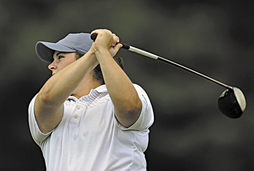 OUT FRONT: Emily Bouchard follows the ball after her drive during the second day of the Maine Women’s Amateur on Tuesday at the Brunswick Country Club course. Bouchard leads the tournament by two strokes.