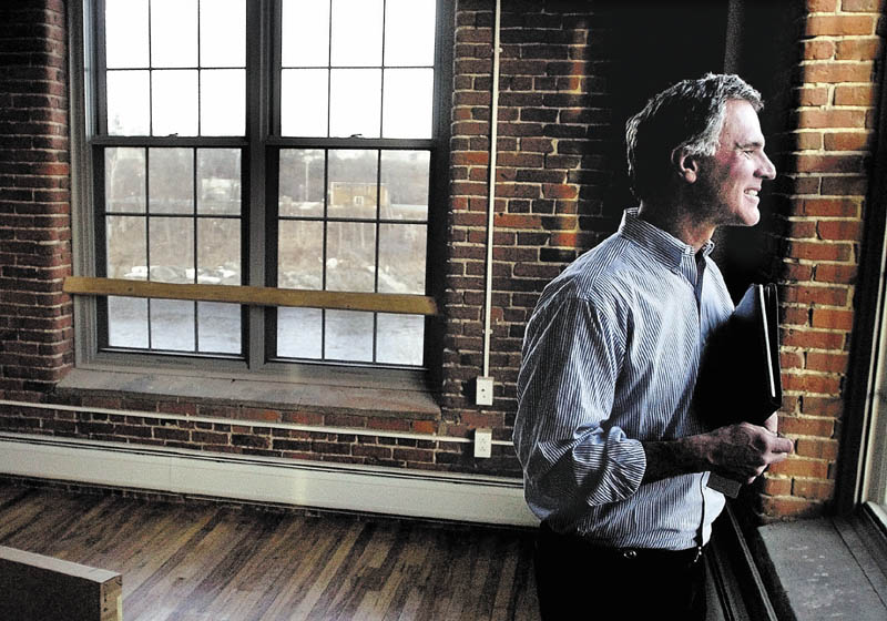 Developer and Colby College alumnus Paul Boghossian enjoys the view of the Kennebec River from one of the apartments in the Hathaway Creative Center in Waterville.