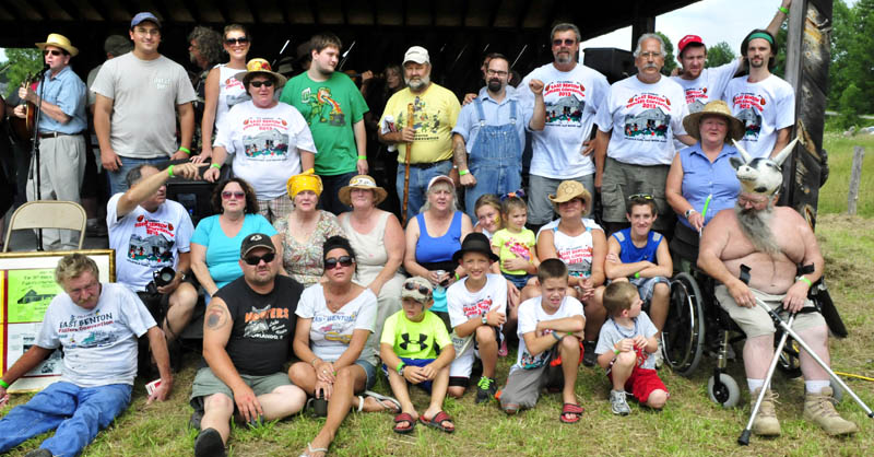The Littlefield family gathered on stage for a group portrait and applause during the East Benton Fiddler's Contest, Convention and Bluegrass Festival today. Shirley and Red Littlefield, now deceased, began the event 41 years ago. Longtime participant Eric Rolfson, at left in background, plays with the East Benton Jug Band.