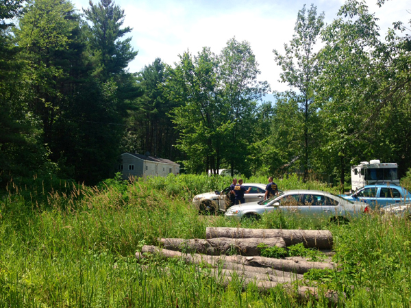 Maine State Police detectives investigate the property at 24 Main Street in Detroit where a male was found dead on Thursday.