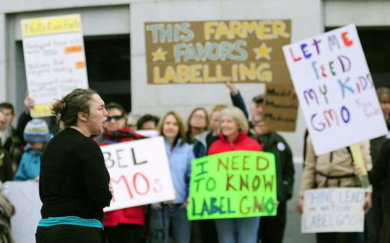 Logan Perkins, Right to Know-GMO Campaign Coordinator for Maine Organic Farmers and Gardeners Association, speaks at a rally outside the Maine State House on Tuesday April 23, 2013. Advocates of a bill that would require food producers to label products containing genetically modified ingredients believe they’ve won a key ally: Gov. Paul LePage.