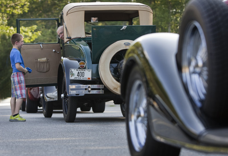 Colter Olson, 7, of Yarmouth talks with Bob Theriault of Cumberland Center before the start of the Yarmouth Clam Festival Parade on Friday in Yarmouth.