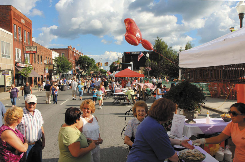 Gail Allen, of Pittsfield, and Teri Philbrick, of Clinton, chat while waiting in line Wednesday at the Mainely Brews Restaurant & Brewhouse booth at the Taste of Greater Waterville on Aug. 2, 2011. This year's Taste will see the return of sit-down dining, according to organizers.