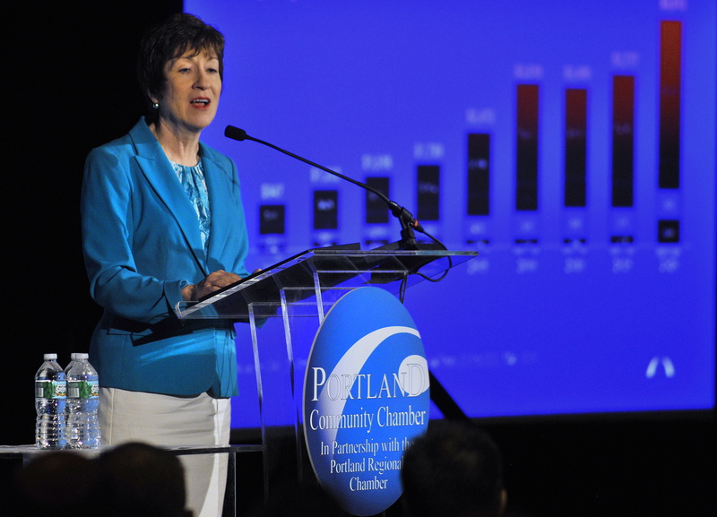 Sen. Susan Collins refers to a chart during her speech Thursday in South Portland.