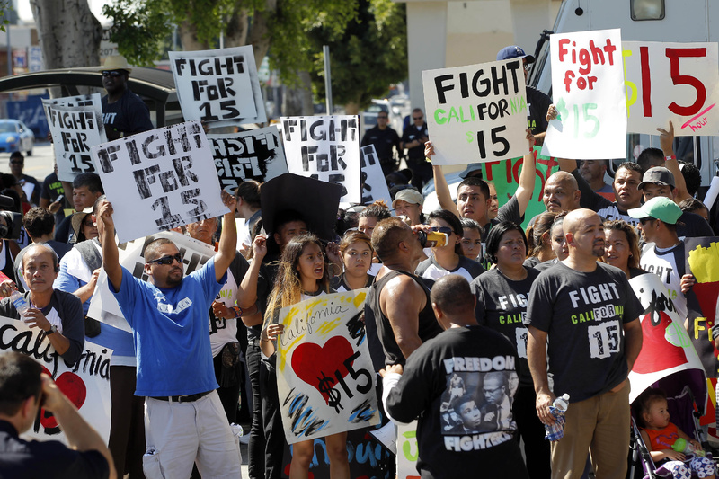 2014 photo: Protesters demonstrate outside a fast-food restaurant in Los Angeles. Fast-food protests were under way Thursday in U.S. cities, including New York, Chicago and Detroit, with organizers expecting the biggest national walkouts yet in a demand for higher wages.