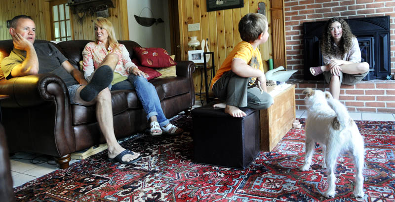 Maine Army National Guard Maj. Scott Lewis speaks with his wife, Lynn, as their children, Nathan, 6, and Kimberlee, 16, play in the family's Monmouth home on today. Scott Lewis is deploying to Afghanistan to serve as the executive officer for the 133rd Engineer Battalion.