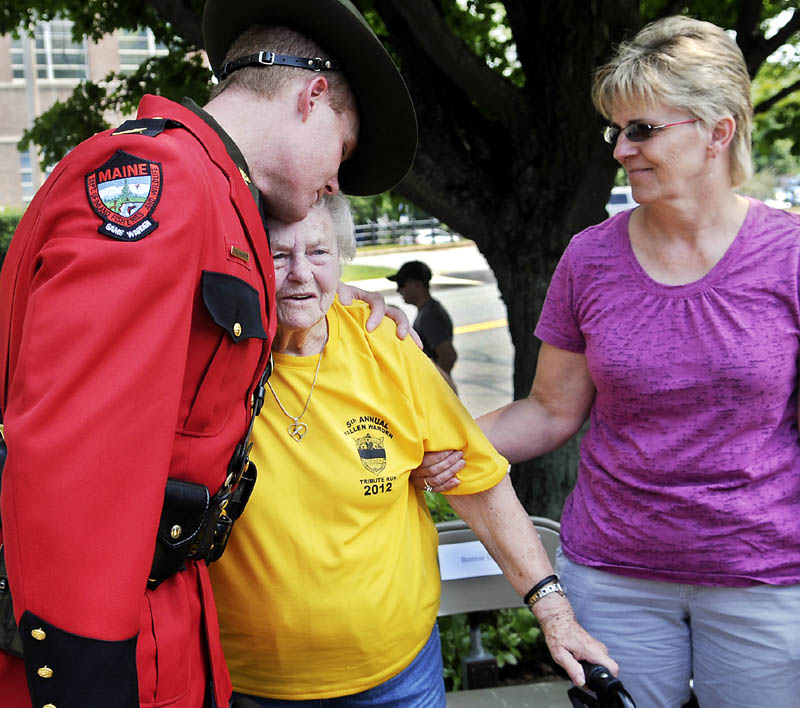 Camilla Nutter, center, the mother of deceased Warden Service pilot Daryl Gordon, is hugged Maine Warden Service Col. Joel Wilkinson today during the Ride4Cops ceremony in Augusta she attended with her daughters, Bonnie Lawrence, right, and Holli Stedman. A 25-year veteran of the Warden Service, Gordon died when the plane he was flying crashed on March 24, 2011.