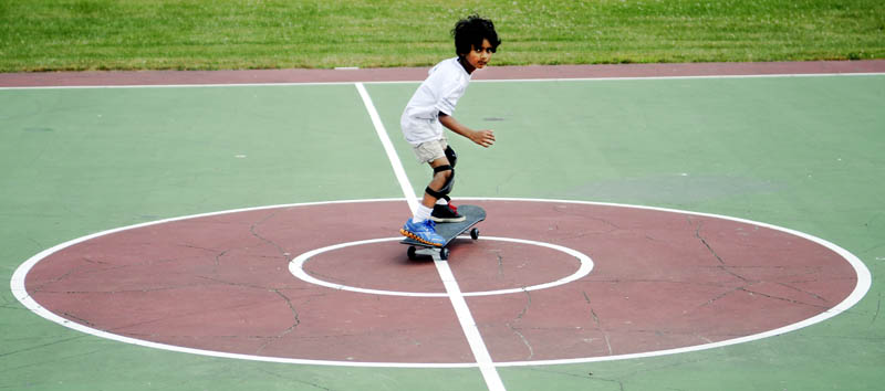 Aryan Das, 6, skates across center court today at Williams Playground in Augusta. The Augusta resident graduated from a scooter this week to roll without handle bars on the skateboard, according to his father, Anupam Das. "I like it now," the younger Das said.