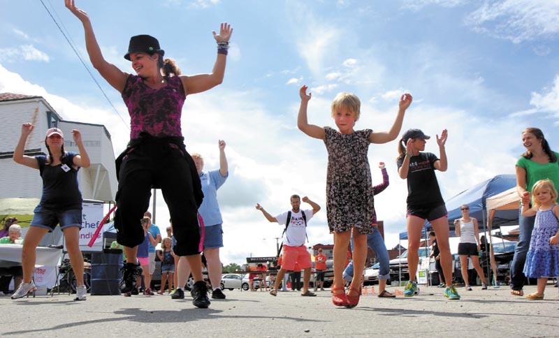 Natalie Cooke, 5, of Cornville, right, follows instructor Monica Gilbert Beach, of Fairfield, near left, during a Zumba session at Move More Kids Day at the Skowhegan River Fest today. The child-centered day included a handful of activities to promote healthy living and was sponsored by the New Balance Foundation and Greater Somerset Public Health Collaborative.