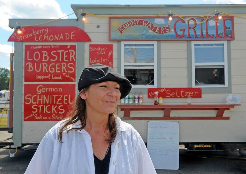 Johanna Franz, of Trescott, stands by her Sunny-Waters Grille cart at the 195th annual Skowhegan State Fair at the Skowhegan Fairgrounds today.