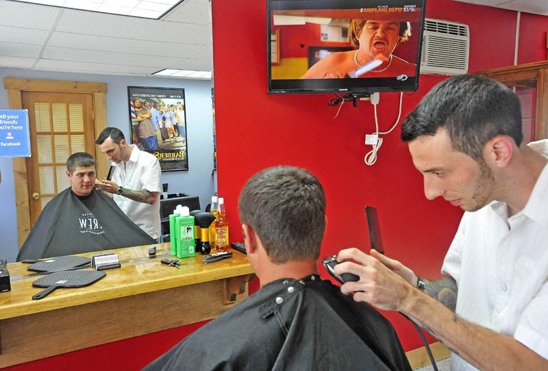 Derrik Vigue, trims the neck of Josh Gilbert, 23, of Oakland, during a cut at Faded Lines Barber Shop at 99 Church St. in Oakland on Thursday.