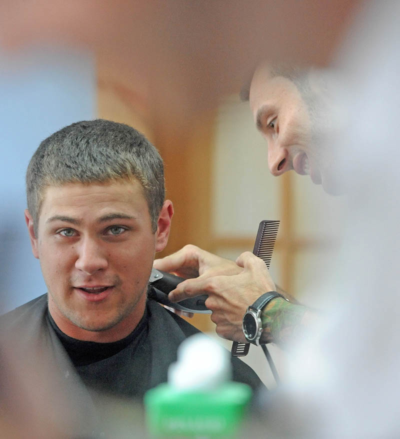 Derrik Vigue trims the neck of Josh Gilbert, 23, of Oakland, during a cut at Faded Lines Barber Shop at 99 Church St. in Oakland on Thursday.