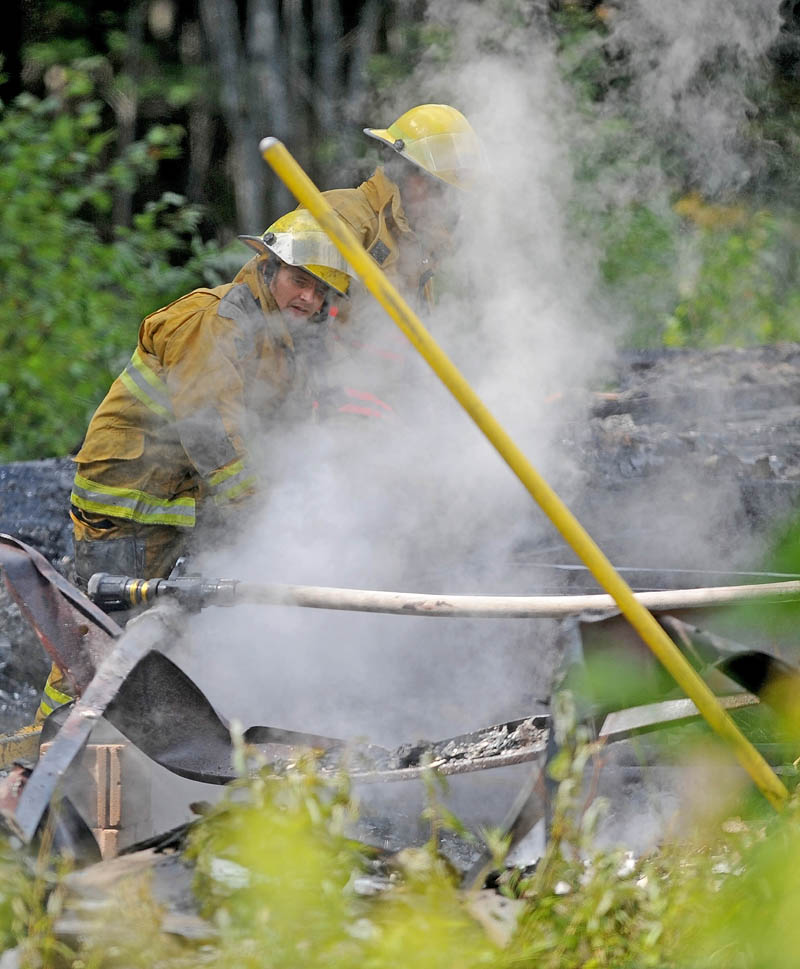 Firefighters from Burnham and Unity mop up a mobile home fire on Pond Road in Burnham today.