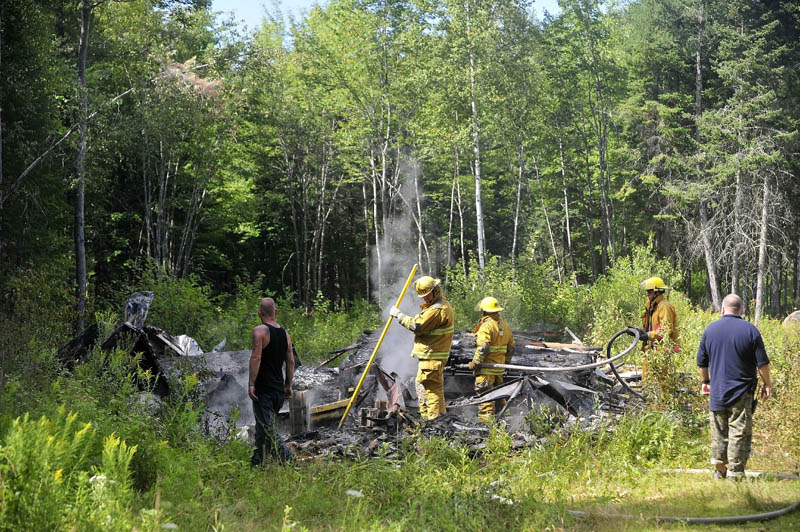 Firefighters from Burnham and Unity mop up a mobile home fire on Pond Road in Burnham today. The structure was destroyed. Firefighters from Troy and Pittsfield were also on scene.