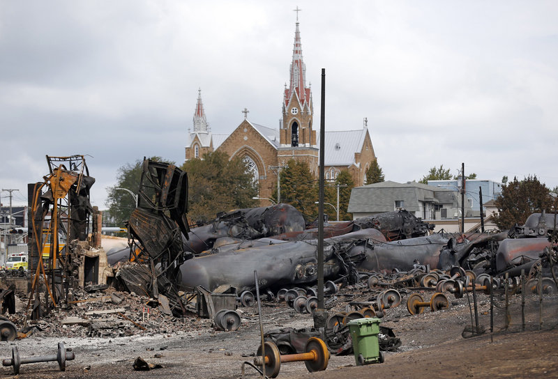Wagons of the train wreck are seen in Lac Megantic, July 9, 2013.A federal judge authorized the Montreal, Maine & Atlantic Railway on Thursday to keep running and pay its expenses while it seeks to reorganize under bankruptcy protection following a fiery Quebec crash that killed 47 people. (REUTERS/Mathieu Belanger) :rel:d:bm:GF2E97916XN01