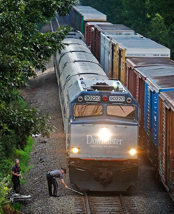Police and fire personnel investigate the scene of a pedestrian-train accident off Highland Avenue in Scarborough on Sunday.