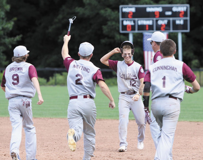 IN GOOD SHAPE: Players run onto the field to congratulate Ben Frazee after he hit an RBI single in the bottom of the ninth inning to give Central Maine a 3-2 win over Eastern Mass. on Sunday in Newtown, Conn. Central Maine is 2-0 in the tournament and faces Cranston, R.I. today for a berth in the championship portion of the tournament. regionals game two 2013