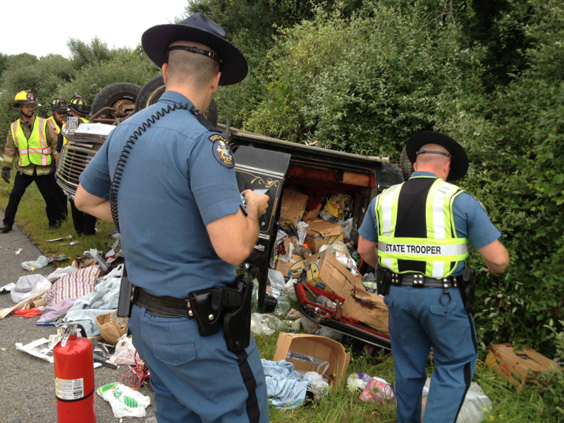 State police troopers examine the scene of a single-vehicle rollover at Interstate 95 exit 112A in Augusta in which a Solon man died.