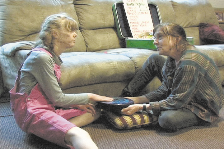 Ellen Bowman, right, a counselor at Belgrade Central School, has worked with Cathy Chafin, the daughter of an Augusta woman, for the last eight years. Chafin, 45, is nearly non-verbal, so she uses music as a tool to communicate and interact with others, with Bowman's help.