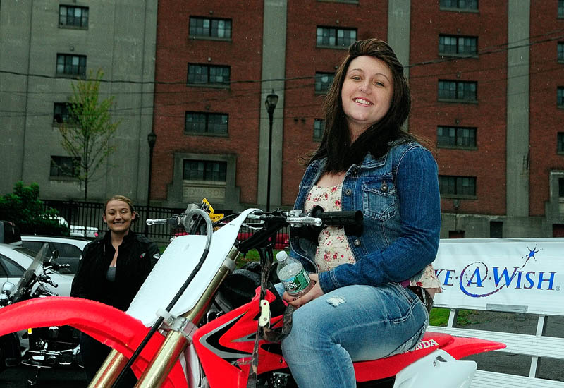 Kate McPherson, 17, of Litchfield, tries out the new Honda CRF 150 that she received during a Make-A-Wish Maine event on Saturday in the parking lot of the Fraternal Order of Eagles 3137 in Augusta.