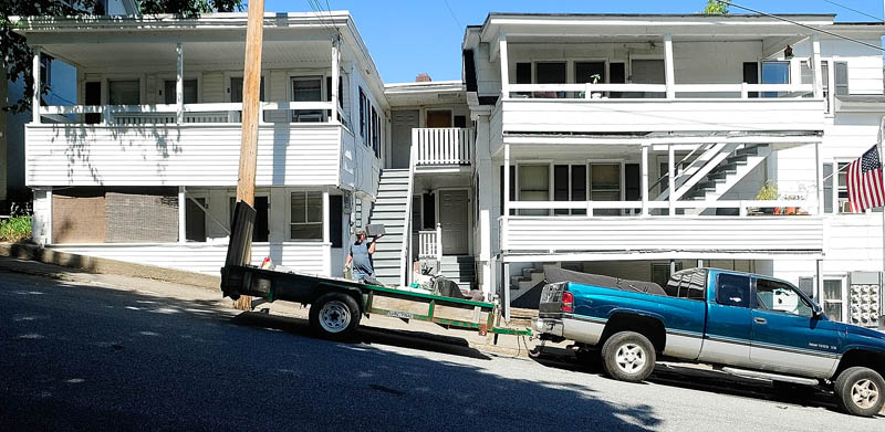 Eric Smith loads up a trailer as he helps his friend, William Throp, who had to move on short noticetoday from 9 Laurel St. in Augusta.