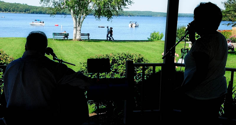 Robert Simons, left, and Renee Goodwin perform in the gazebo at Norcross Poin on Sunday in Winthrop. The folk duo performs as Simons and Goodwin and they were the first half of the final Sunday of the annual summer concert series. Bertha's Crib played after them.