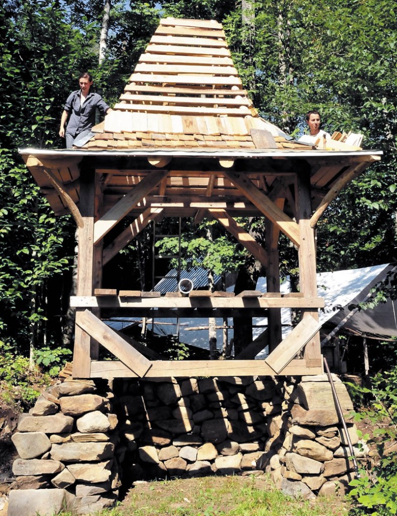 Ashley Hardy and Chris Knapp build a new composting outhouse at the Koviashuvik Living School in Starks recently.