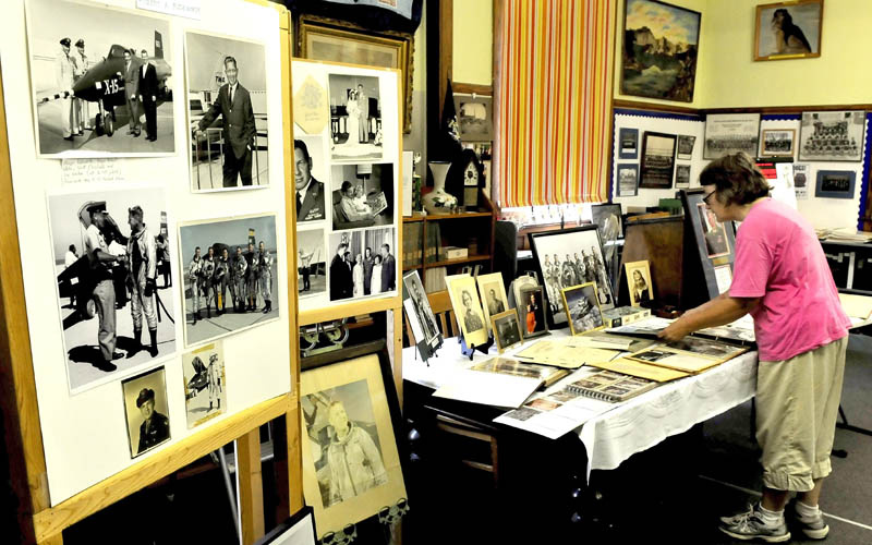 Elizabeth Ackroyd looks over photographs and memorabilia of Air Force Major Robert Rushworth at the Madison Historical Society on Thursday. The exhibit is part of the Madison-Anson Days event.