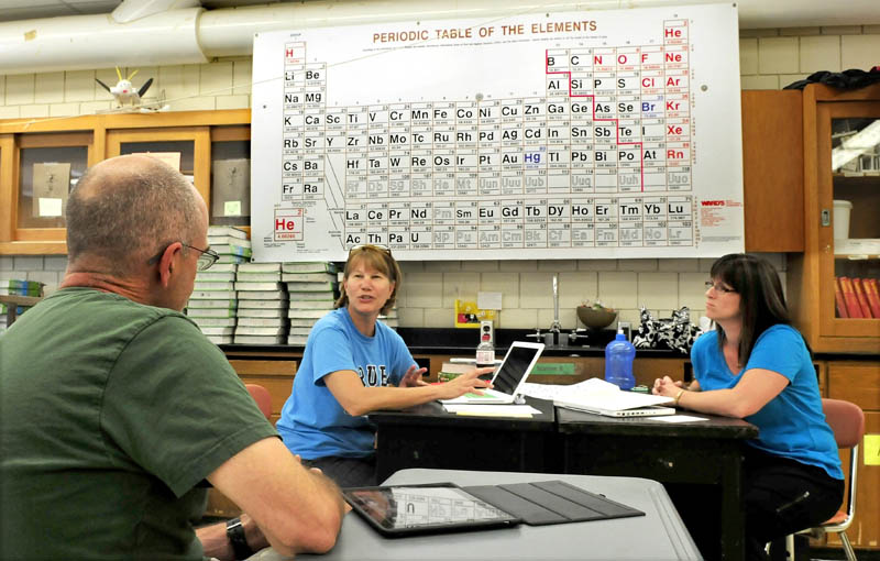 Skowhegan Area High School science teachers Scott Pillsbury, Barbara Toner and Stephani Sawyer-Main prepare curriculum for the new school year recently.