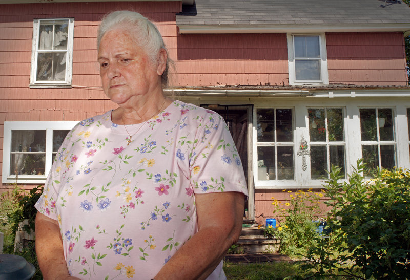 Glenna Dean talks about the July 6 rail disaster in Lac-Megantic, Quebec, while standing in her Brownville yard last week. The wife of the pastor at the United Methodist Church, she worries about the fate of her rail-dependent town, where dozens of workers have been laid off.