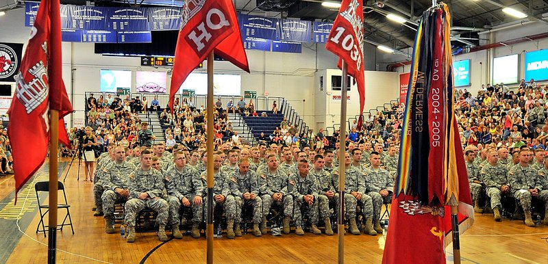 Flags and banners frame the troops during a send-off ceremony Saturday for the 133rd Engineer Battalion and the 1035th Survey and Design Team at the Portland Expo in Portland. The soldiers were chosen for a one-year deployment to Afghanistan.