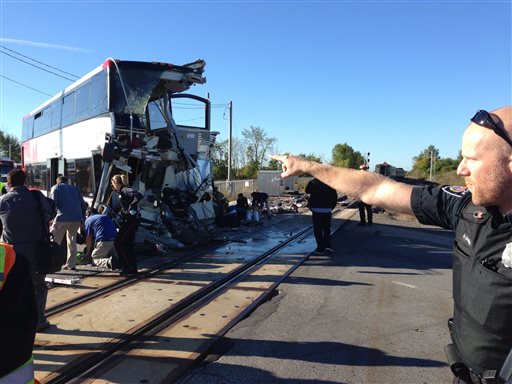 Officials respond to the scene where a city bus collided with a Via Rail passenger train at a crossing in Ottawa, Ontario, Wednesday. An Ottawa Fire spokesman said there are "multiple fatalities" and a number are injured from the bus with no injuries on the train. (AP Photo/The Canadian Press, Terry Pedwell)