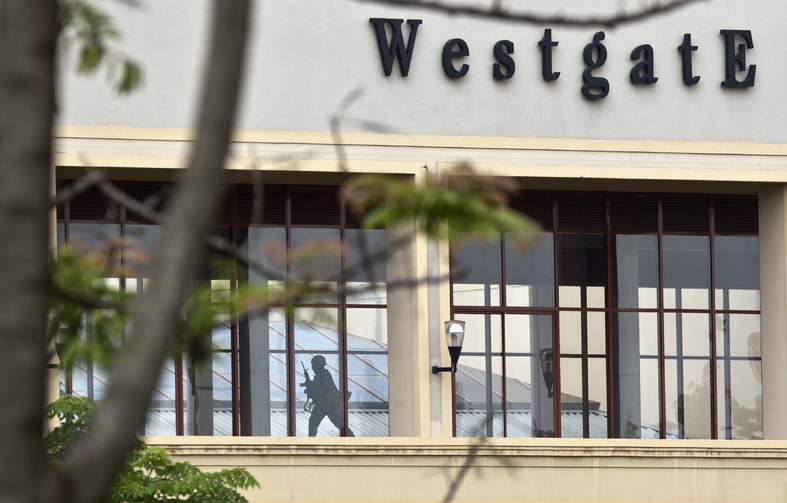 A Kenyan soldier runs through a corridor on an upper floor of the Westgate Mall shortly before an explosion was heard, in Nairobi, Kenya, on Tuesday.