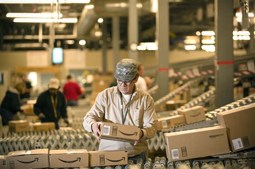 In this 2008 file photo, an Amazon.com employee grabs boxes off the conveyor belt to load in a truck at their Fernley, Nev. warehouse. Amazon, the online retailing giant, is fighting Maine's new law to collect taxes from Internet sales by ending its relationship with digital entrepreneurs in the state.