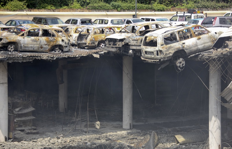 This photo released by the Kenya Presidency shows the collapsed upper car park of the Westgate Mall in Nairobi, Kenya Thursday, Sept. 26, 2013. Working near bodies crushed by rubble in a bullet-scarred, scorched mall, FBI agents continued fingerprint, DNA and ballistic analysis to help determine the identities and nationalities of victims and al-Shabab gunmen who attacked the shopping center, killing more than 60 people. (AP Photo/Kenya Presidency)