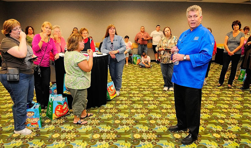 Chef Michael Barna talks to a group of Taste of Home Cooking School Show attendees in the preshow, VIP reception today at the Augusta Civic Center. After the reception, Barna said that he was going to work with Capital Area Technical Center culinary arts students who assisting with the show. The Kennebec Journal sponsored the show.