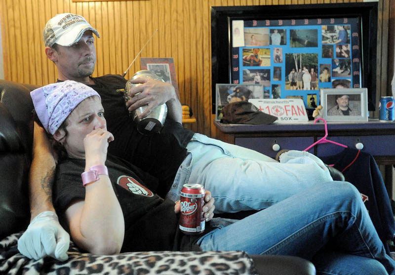 Melissa Nelson, 38, and Jeremy Nelson, 39, recall their brother Christopher Nelson's life, as Jeremy clutches his brother's remains, at the family's Pease Hill Road residence in Anson on Wednesday.