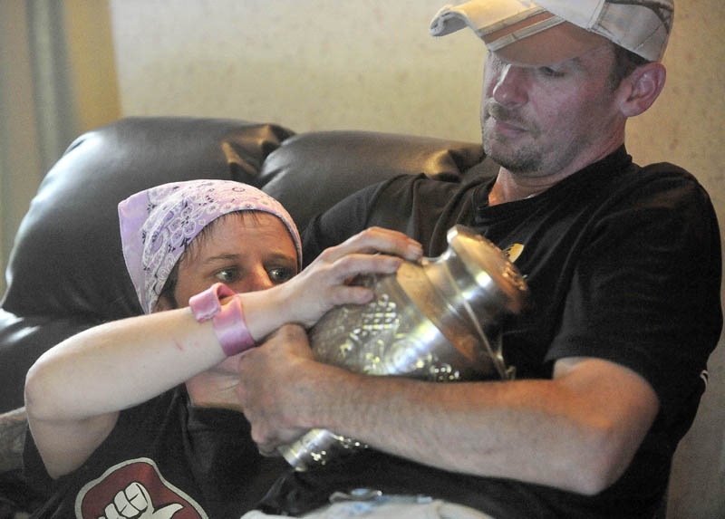 Melissa Nelson, 38, and Jeremy Nelson, 39, recall their brother Christopher Nelson's life, as Jeremy clutches his brother's remains, at the family's Pease Hill Road residence in Anson on Wednesday.
