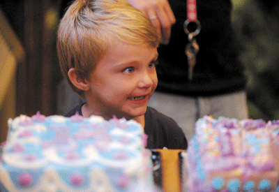 Harley Raymond, 4, gets wide eyes as he waits for a piece cake during the opening night festivities of the first Cirque du Geek convention at the Waterville Public Library on Friday. Cirque du Geek will run through Sunday and includes cosplays, making misters and plashes, watching movies along with a geek parade and a geek picnic.