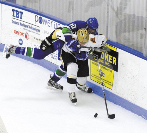 IT’S MINE: Maine Wild’s Ignat Molchanov (10) and Maine Moose’s Matt Woodbury tangle over a loose puck behind the Wild’s net Saturday at the Bank of Maine Ice Vault in Hallowell.