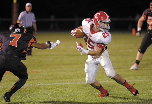 Cony's Tayler Carrier looks for running room after slipping past Brunswick's Taran Payne during the first half of the Rams' 54-38 loss Friday.