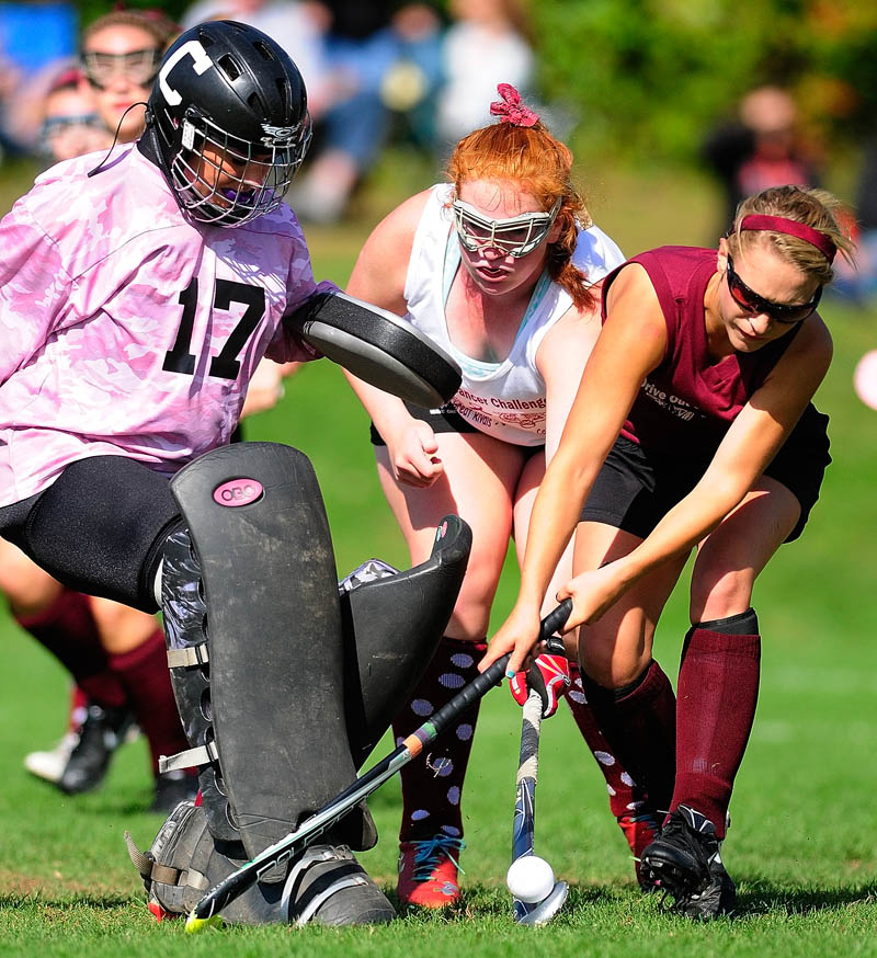 Cony goalkeeper Lindsay Lapierre, left, and Rebecca Coniff try to keep Gardiner's Lily Chepke away from the goal on Saturday in Augusta.
