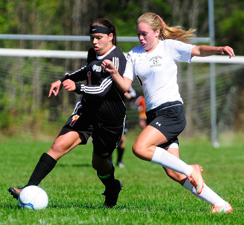 Gardiner's Morgan Carver. left, and Maranacook's Katelyn MacGregor go after the ball during a game on Saturday at the RIcky Gibson Field of Dreams in Readfield.