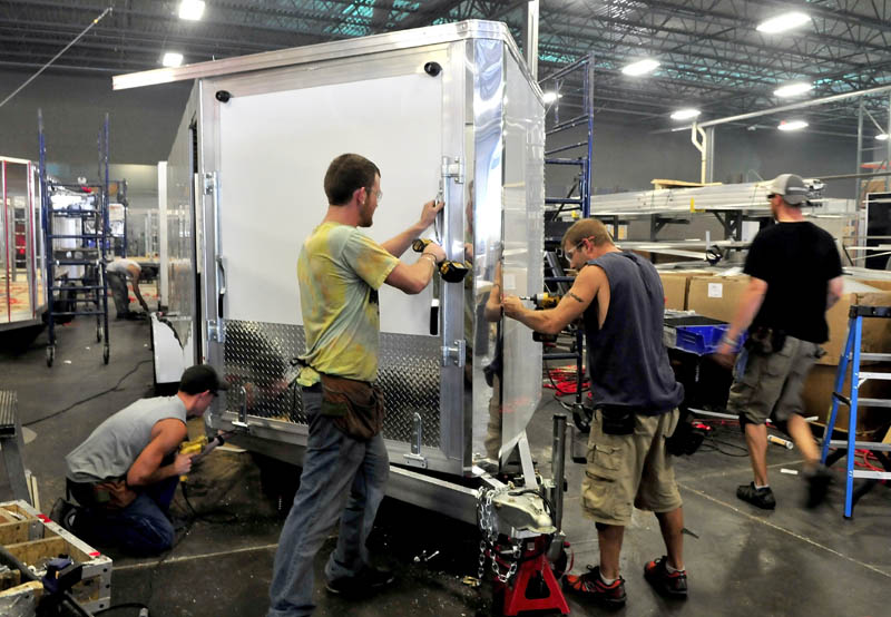 Alcom Inc. employees make a snowmobile trailer at the Winslow company on Wednesday. From left are Alex Garceau, Jeff Buker and Jason Fecteau.