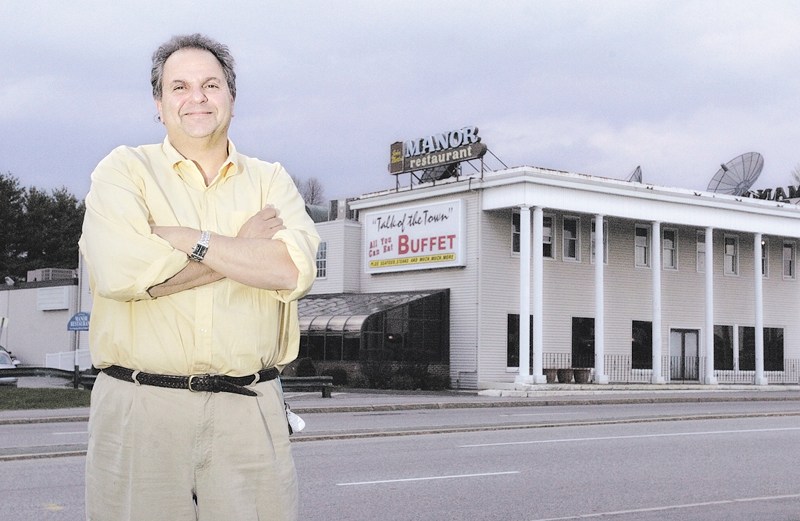 Peter Martin stands in front of the John Martin's Manor Restaurant on College Avenue in Waterville in 2005, shortly before selling the establishment to a Georgia company.
