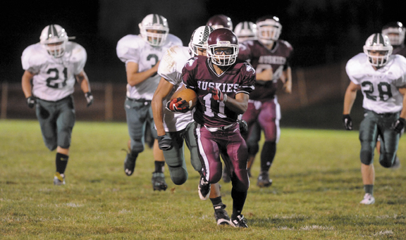 Maine Central Institute running back Jonathan Santiago breaks away from Mt. View High School defenders in Pittsfield on Friday.