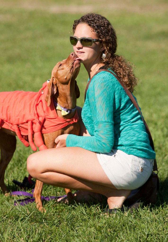 Tracy Tischler of Portland gets a kiss from her lobster-costumed dog Beti, winner of the Cover Dog Challenge and best in show award.