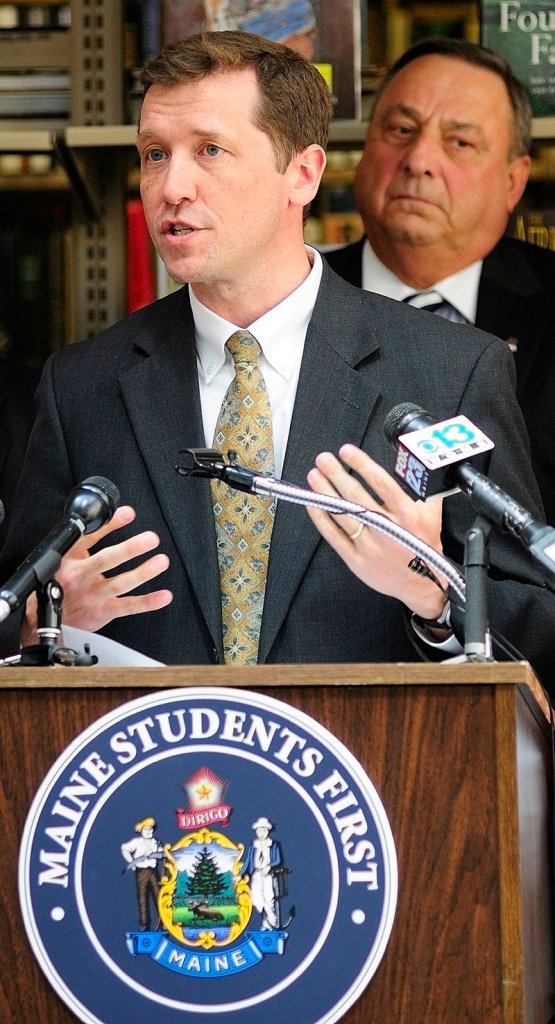 Education Commissioner Stephen Bowen, left, and Gov. Paul LePage unveil the state's new A-F grading system on May 1 at the Maine State Library.
