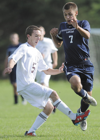 TRIPPED UP: Richmond High School’s Sean Bernier, left, and Greenville High School’s Matt DiAngelo get tangled up during the Bobcats 3-0 win Monday in Richmond. Monday during a soccer match up in Richmond.