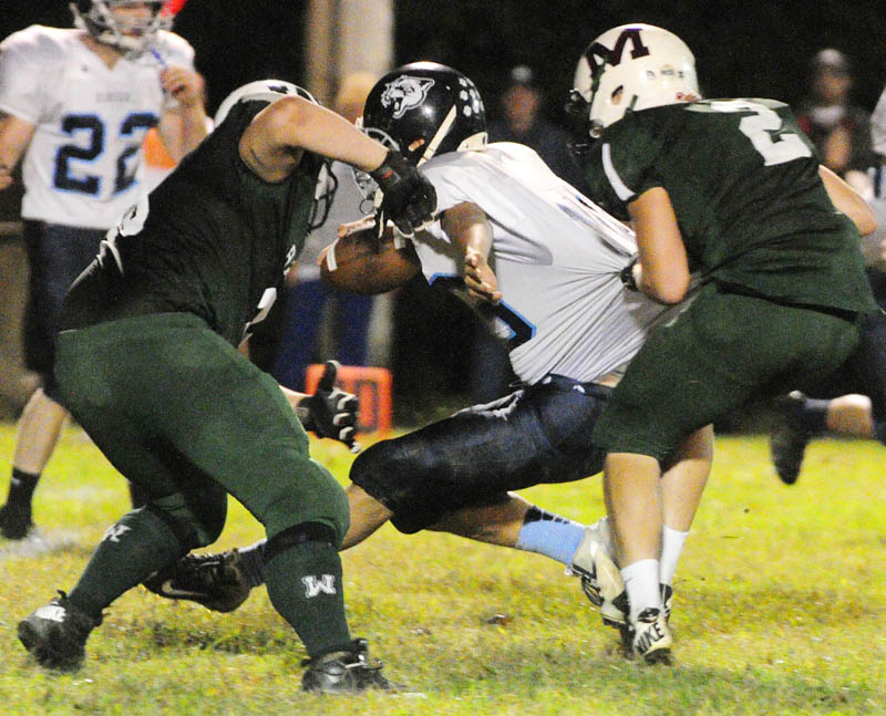 Dirigo quarterback Riley Robinson, center, is sacked by Winthrop-Monmouth's Jeremy Mihilakis, left, and Mario Meucci during the Ramber's 28-14 win Friday in Winthrop.